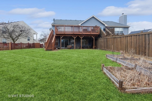 back of house with a wooden deck and a yard