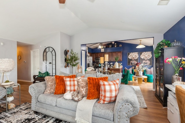 living room with lofted ceiling, light hardwood / wood-style flooring, and ceiling fan