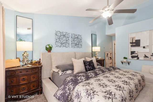 carpeted bedroom featuring lofted ceiling and ceiling fan