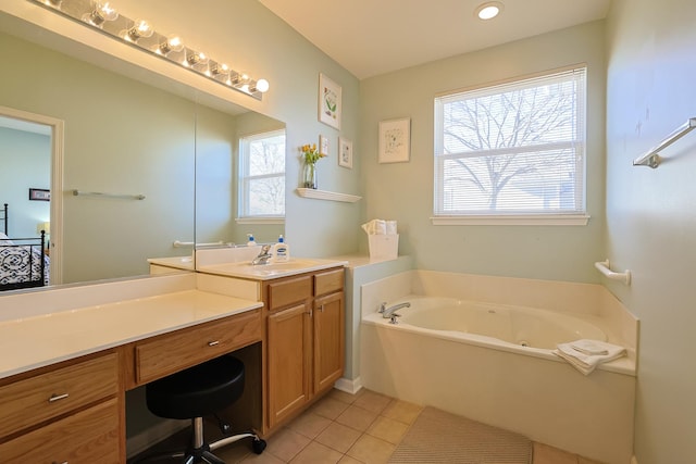 bathroom featuring tile patterned flooring, vanity, and a washtub