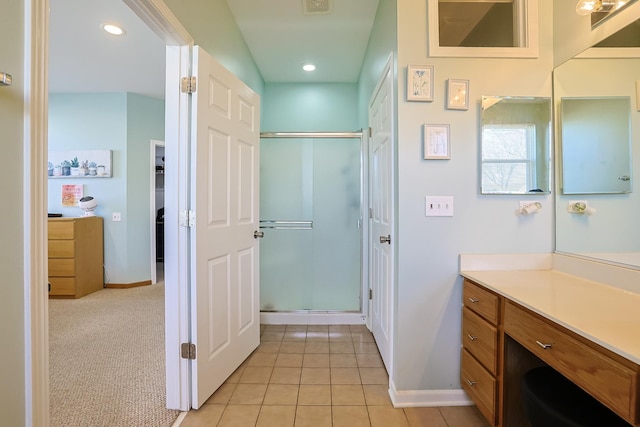 bathroom featuring vanity, tile patterned floors, and a shower with shower door