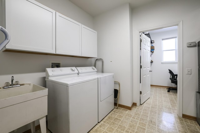 laundry area with cabinets, sink, and washing machine and dryer