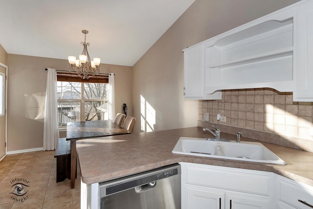 kitchen with decorative light fixtures, dishwasher, sink, and white cabinets