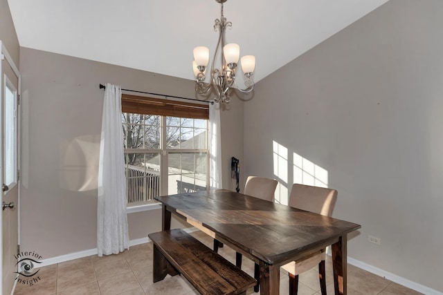 tiled dining room with a notable chandelier and vaulted ceiling