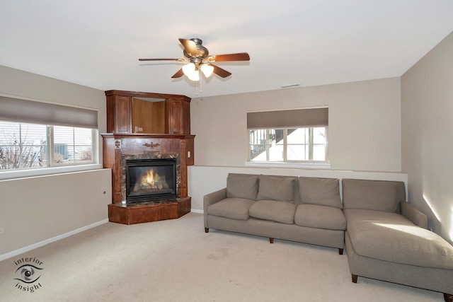 living room featuring ceiling fan and light carpet