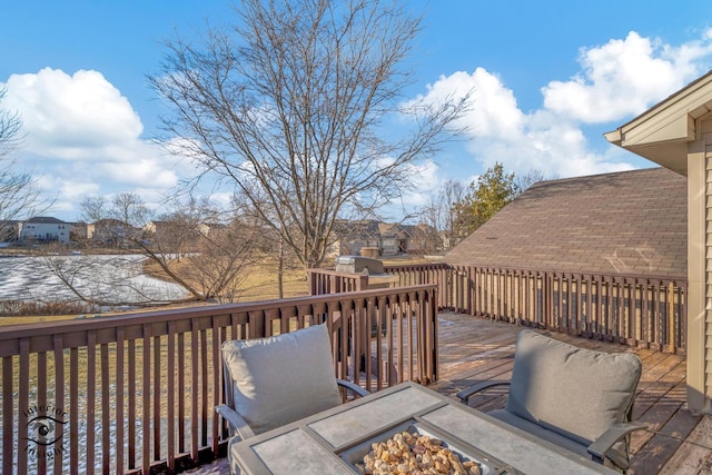 wooden deck featuring an outdoor fire pit