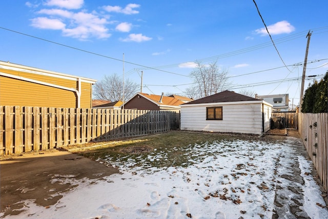 yard layered in snow featuring an outbuilding