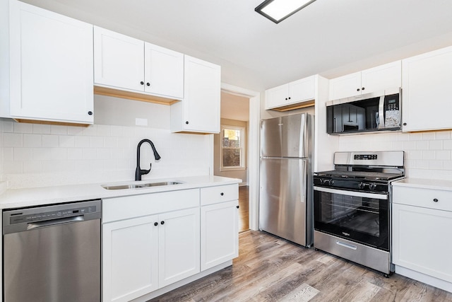 kitchen featuring sink, white cabinets, and appliances with stainless steel finishes