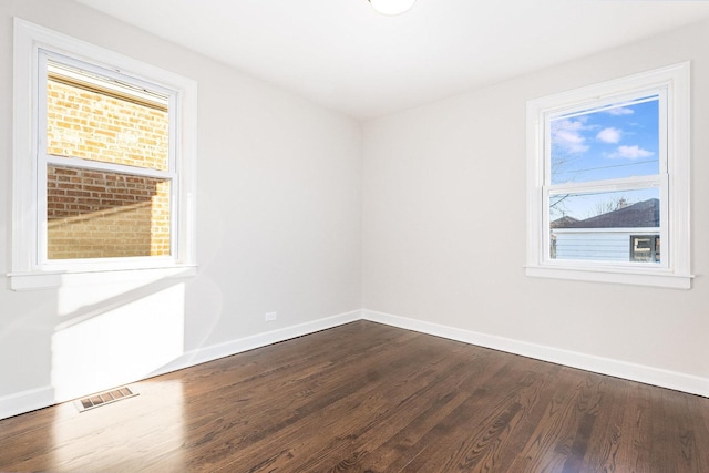 spare room with dark hardwood / wood-style flooring