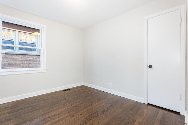 unfurnished room with dark hardwood / wood-style flooring