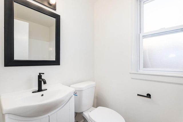 bathroom featuring vanity and toilet