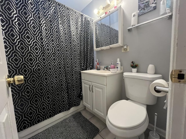 bathroom featuring a shower with curtain, vanity, tile patterned floors, and toilet