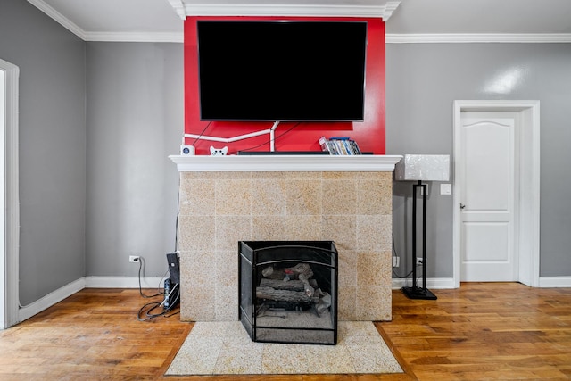 details featuring crown molding, a fireplace, and hardwood / wood-style flooring