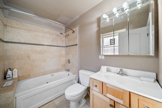 full bathroom with vanity, tiled shower / bath combo, tile patterned floors, and toilet