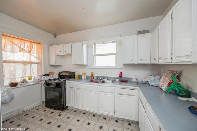 kitchen with white cabinetry, gas stove, and sink