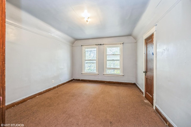 unfurnished room with lofted ceiling and carpet