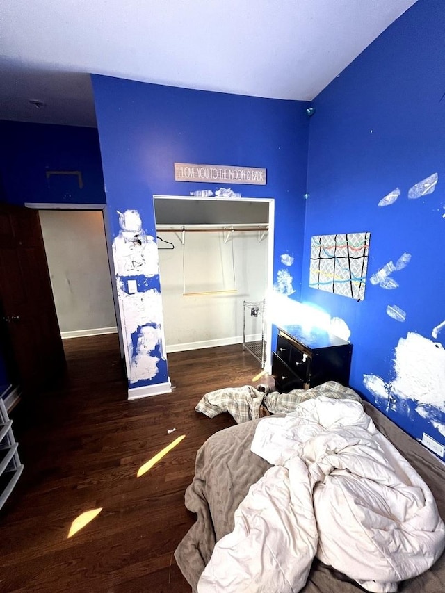 bedroom with hardwood / wood-style floors and a closet