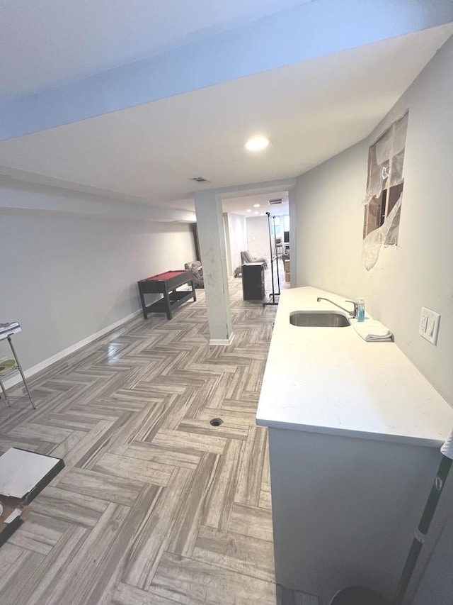 interior space featuring parquet flooring and sink