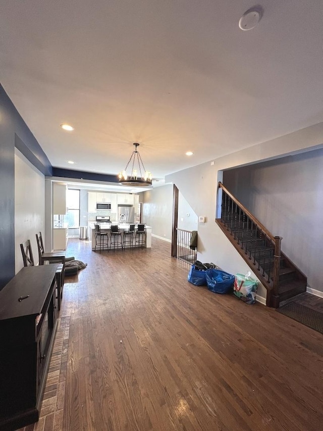 living room with a notable chandelier and wood-type flooring