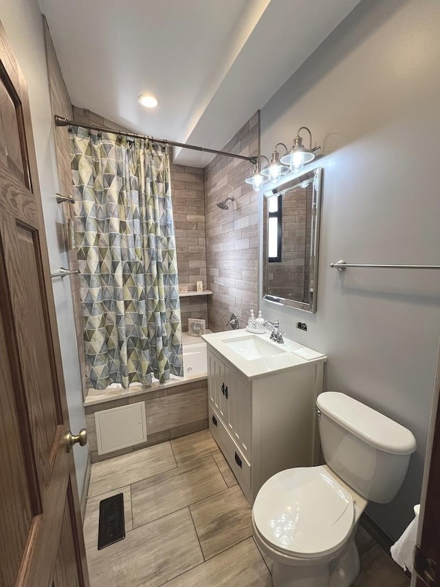 full bathroom featuring vanity, toilet, and shower / bath combo with shower curtain