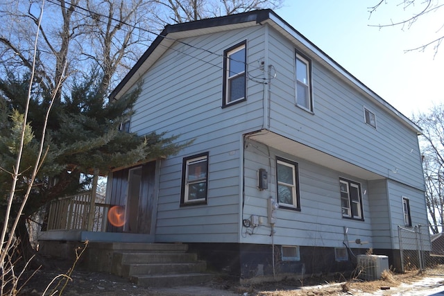 rear view of property with central AC unit