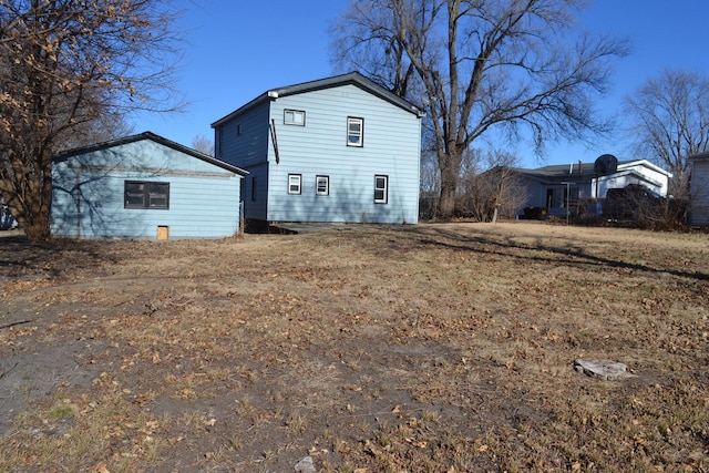 rear view of property with a yard