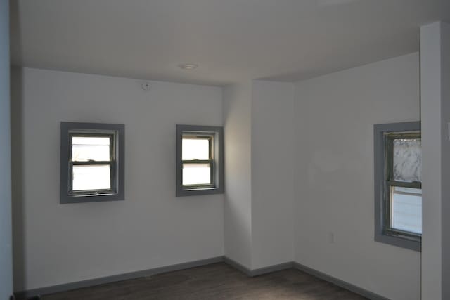 unfurnished room featuring dark hardwood / wood-style floors