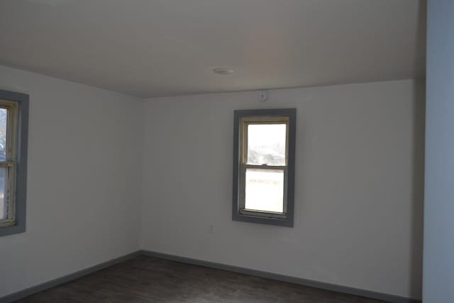 unfurnished room featuring dark wood-type flooring