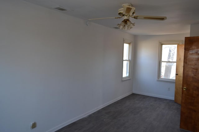 empty room featuring dark hardwood / wood-style floors and ceiling fan