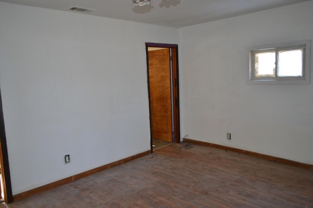 empty room featuring dark wood-type flooring