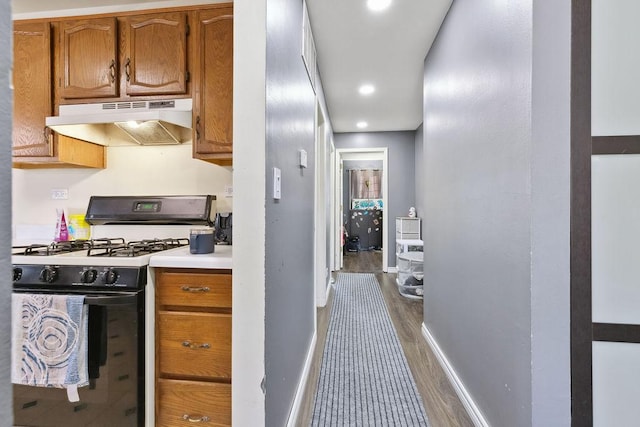 kitchen featuring dark hardwood / wood-style flooring and range with gas cooktop