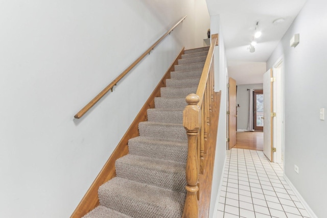 staircase with tile patterned floors