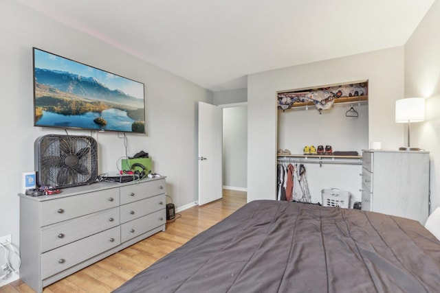 bedroom with a closet and light hardwood / wood-style flooring