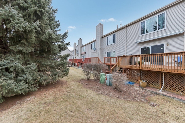 back of house featuring a yard and a deck