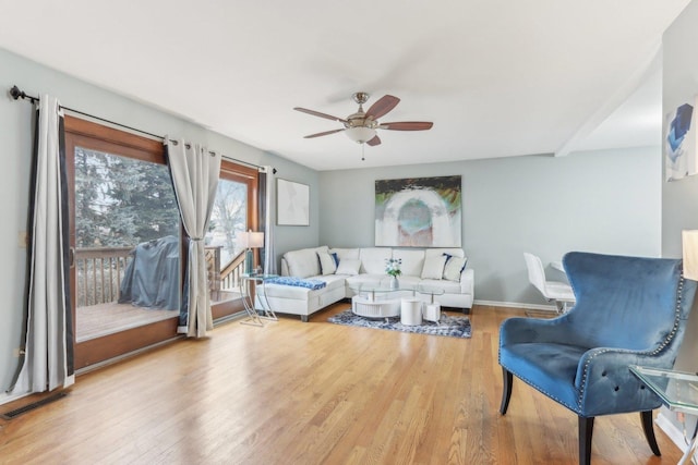 living room featuring hardwood / wood-style flooring and ceiling fan