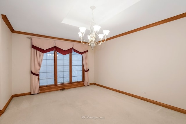 carpeted spare room featuring crown molding, a tray ceiling, and a notable chandelier