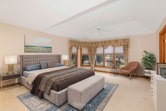 bedroom with a raised ceiling and ceiling fan