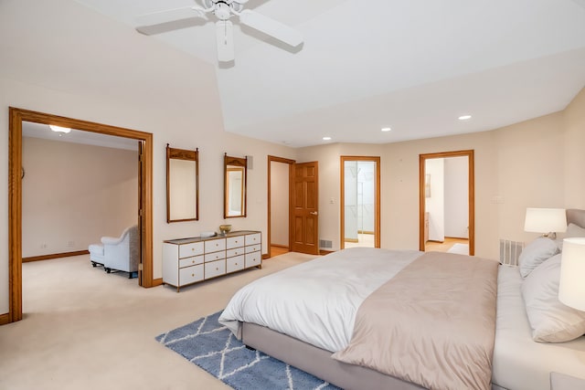 carpeted bedroom featuring vaulted ceiling, connected bathroom, and ceiling fan