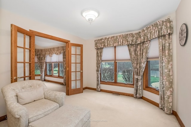 living area with carpet flooring and french doors