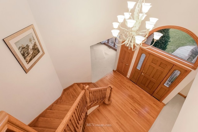 foyer entrance featuring hardwood / wood-style floors and a chandelier