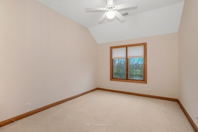 carpeted spare room with vaulted ceiling and ceiling fan