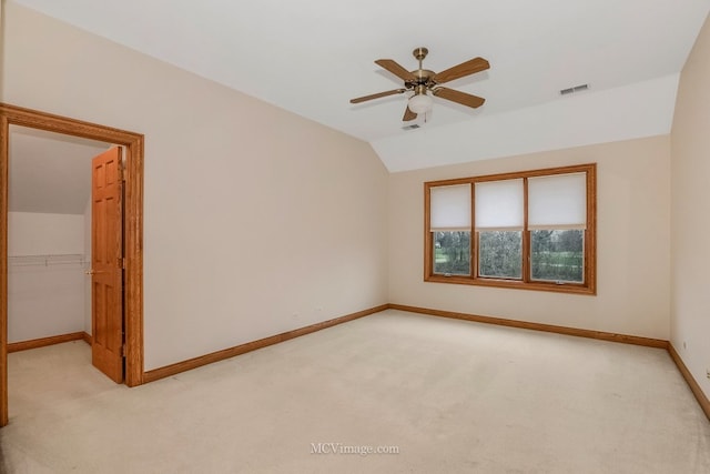 carpeted empty room with lofted ceiling and ceiling fan