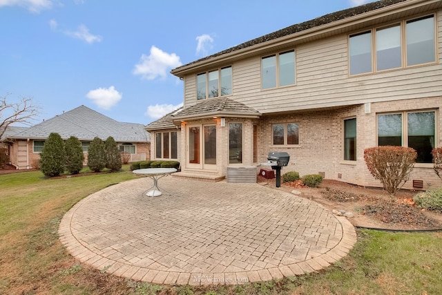 back of house featuring a patio and a lawn