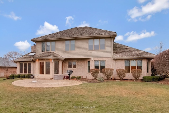 back of property featuring a yard and a patio