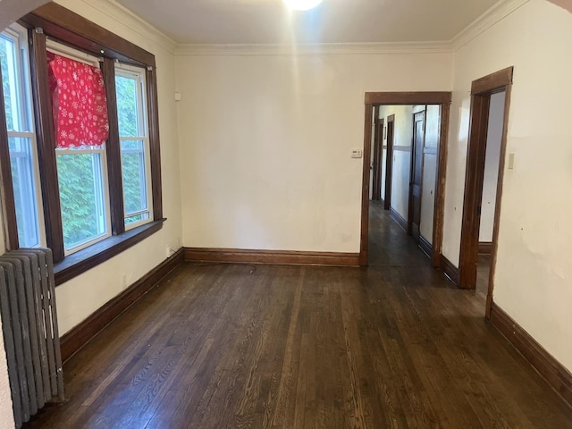 empty room with radiator, crown molding, and dark wood-type flooring