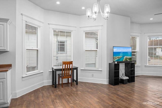 dining area with dark hardwood / wood-style floors and a notable chandelier