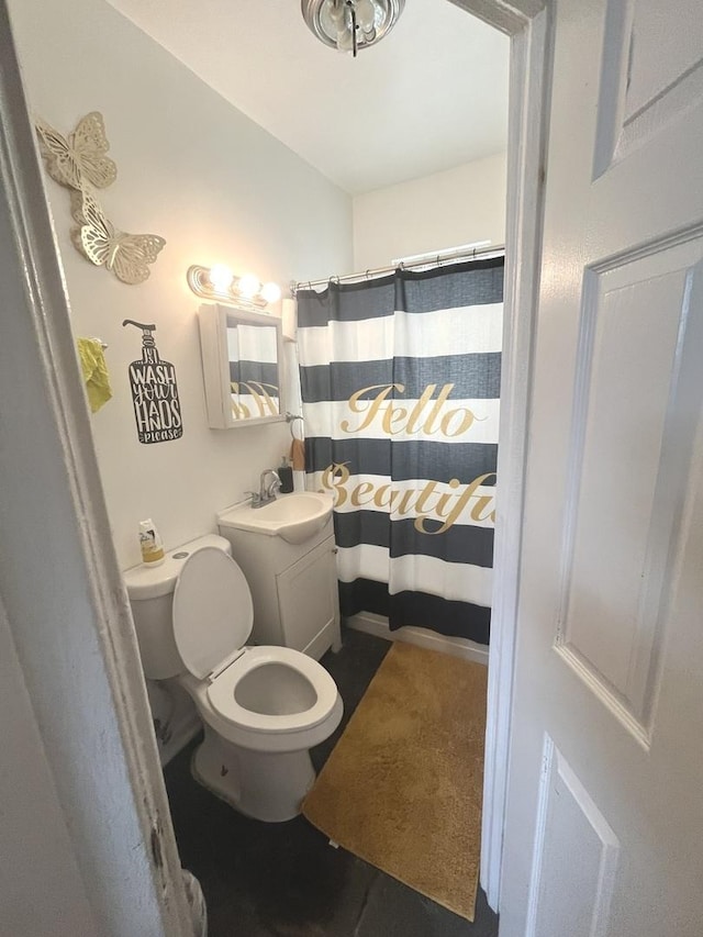 bathroom with vanity, a shower with shower curtain, and toilet