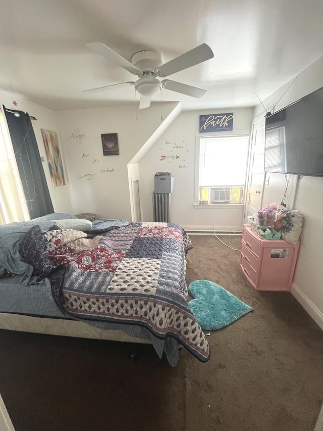 bedroom with ceiling fan and dark colored carpet