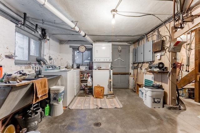 basement with stacked washer and dryer and electric panel