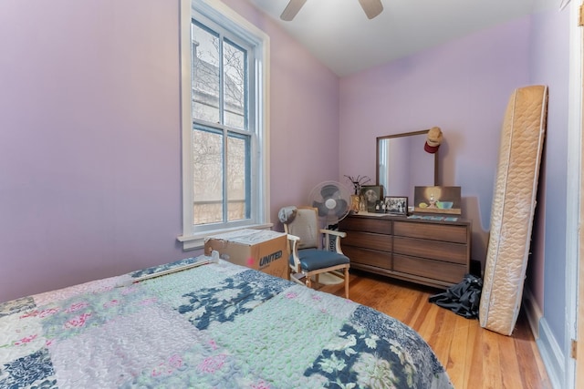 bedroom with lofted ceiling, ceiling fan, and light hardwood / wood-style flooring